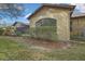 A view of the side exterior of a home with an arched window at 2224 Vista Royal Way, Spring Hill, FL 34606