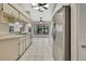 Bright eat-in kitchen features stainless steel refrigerator and white cabinetry at 2224 Vista Royal Way, Spring Hill, FL 34606