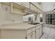 Kitchen with stainless steel dishwasher and white cabinets at 2224 Vista Royal Way, Spring Hill, FL 34606