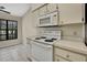 Bright kitchen features white appliances and ample counter space at 2224 Vista Royal Way, Spring Hill, FL 34606