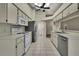 Open kitchen features white appliances and tile flooring at 2224 Vista Royal Way, Spring Hill, FL 34606