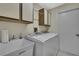 Laundry room with a washer and dryer, storage cabinets, and a utility sink at 2224 Vista Royal Way, Spring Hill, FL 34606