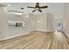 Bright open concept living room featuring vaulted ceilings, light hardwood floors and natural light at 2224 Vista Royal Way, Spring Hill, FL 34606