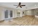 Bright living room features French doors and wood-look floors at 2224 Vista Royal Way, Spring Hill, FL 34606