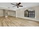 Living room featuring hardwood floors, neutral walls and a large arched window allowing for natural light at 2224 Vista Royal Way, Spring Hill, FL 34606