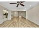 Open living room boasts wood-look floors and views to other rooms at 2224 Vista Royal Way, Spring Hill, FL 34606
