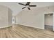 Open-concept living space with vaulted ceiling, ceiling fan, and light wood-look flooring at 2224 Vista Royal Way, Spring Hill, FL 34606
