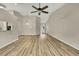 Large open-concept living room showing vaulted ceiling, hardwood floors and pendant lighting at 2224 Vista Royal Way, Spring Hill, FL 34606