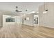 Bright and airy living room featuring vaulted ceilings, light hardwood floors and natural light at 2224 Vista Royal Way, Spring Hill, FL 34606