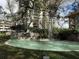 Exterior view of the building's atrium, highlighting a decorative fountain and lush, mature landscaping at 2413 Bayshore Blvd # 205, Tampa, FL 33629