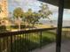 Balcony view offering a glimpse of the pool area and water views beyond the palm trees at 2413 Bayshore Blvd # 205, Tampa, FL 33629