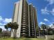 Stunning exterior view of tall condo building featuring multiple balconies and palm trees at 2413 Bayshore Blvd # 205, Tampa, FL 33629