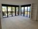 Bright living room with plush carpeting and a sliding glass door leading to a balcony with water views at 2413 Bayshore Blvd # 205, Tampa, FL 33629
