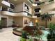 Beautiful atrium-style lobby with tiered fountain and lush plants at 2413 Bayshore Blvd # 205, Tampa, FL 33629
