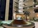 Grand lobby featuring a tiered fountain, lush greenery, and views of multiple floors with planters at 2413 Bayshore Blvd # 205, Tampa, FL 33629