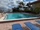Resort-style pool with lounge chairs and lush tropical landscaping at 2413 Bayshore Blvd # 205, Tampa, FL 33629