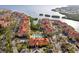 High angle showcases a community featuring a clubhouse, community pool, and nearby waterfront at 2713 Via Murano # 216, Clearwater, FL 33764