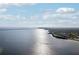Expansive aerial view showcasing the waterfront property and surrounding coastal scenery under a sunny, cloudy sky at 2713 Via Murano # 216, Clearwater, FL 33764