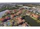 Aerial view of waterfront community with pools, tennis courts, and beautifully landscaped grounds at 2713 Via Murano # 216, Clearwater, FL 33764