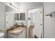 Bathroom featuring a granite vanity, modern fixtures, and a view into the bedroom at 2713 Via Murano # 216, Clearwater, FL 33764