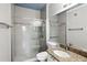 Modern bathroom with a glass-enclosed shower, white subway tile, and a granite-topped vanity at 2713 Via Murano # 216, Clearwater, FL 33764