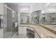 Bathroom with tiled walk-in shower and granite countertop vanity with large mirror at 2713 Via Murano # 216, Clearwater, FL 33764