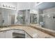 Bathroom with a double sink vanity, granite countertops, and tiled walk-in shower at 2713 Via Murano # 216, Clearwater, FL 33764
