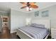 Comfortable bedroom featuring a ceiling fan and a coastal theme with boat-themed artwork at 2713 Via Murano # 216, Clearwater, FL 33764