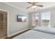 Bedroom with two beds, a wall-mounted TV, and natural light from the windows at 2713 Via Murano # 216, Clearwater, FL 33764