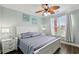 Charming bedroom with a queen bed, coastal decor, and a ceiling fan for added comfort at 2713 Via Murano # 216, Clearwater, FL 33764