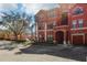 Stylish red condo complex with attached garages and beautiful surrounding greenery at 2713 Via Murano # 216, Clearwater, FL 33764