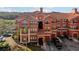 Multi-story building featuring a red tile roof, balconies, and garages for convenient parking at 2713 Via Murano # 216, Clearwater, FL 33764