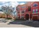 Stylish red condo complex with attached garages and beautiful surrounding greenery at 2713 Via Murano # 216, Clearwater, FL 33764