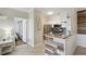 Hallway leads to a kitchen with granite countertops and stainless steel appliances, and a bedroom at 2713 Via Murano # 216, Clearwater, FL 33764