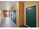 Hallway with neutral-colored walls and a green door leading to the outside at 2713 Via Murano # 216, Clearwater, FL 33764