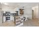 Kitchen featuring granite countertops, white cabinets, and stainless steel appliances, and dining area at 2713 Via Murano # 216, Clearwater, FL 33764