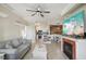 Open-concept living area with fireplace, ceiling fan, and modern furniture at 2713 Via Murano # 216, Clearwater, FL 33764