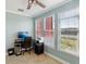 Bright office space with three windows, a ceiling fan, and neutral-colored walls at 2713 Via Murano # 216, Clearwater, FL 33764