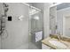 Walk-in shower features gray tile, a glass door, and a mounted shower head and shower bar at 2713 Via Murano # 216, Clearwater, FL 33764