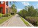 Paver walkway lined with manicured landscaping; showcases vibrant community's appealing outdoor space at 2713 Via Murano # 216, Clearwater, FL 33764