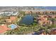 Aerial view of the lake behind the community, showing the pool, palms, surrounding buildings, and community parking at 2713 Via Murano # 216, Clearwater, FL 33764