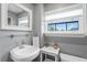 Modern bathroom with a pedestal sink, tile flooring, and window with natural light at 2721 12Th N St, St Petersburg, FL 33704
