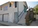 Side exterior features a two-car garage, convenient entry door, and upper-level access stairs at 2721 12Th N St, St Petersburg, FL 33704