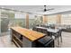 Open-concept living room featuring a kitchen island, dining area, and comfortable lounge seating at 2721 12Th N St, St Petersburg, FL 33704