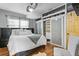 Cozy main bedroom with hardwood floors, large bed, and custom closet at 2721 12Th N St, St Petersburg, FL 33704
