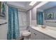 Cozy bathroom with a shower-tub combination, patterned shower curtain, and a white vanity at 3048 Holiday Lake Dr, Holiday, FL 34691