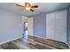This bedroom features wood-look flooring, a ceiling fan, and an ensuite bath at 3048 Holiday Lake Dr, Holiday, FL 34691