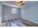 Bright bedroom showcasing a window, vinyl flooring, and neutral colored walls at 3048 Holiday Lake Dr, Holiday, FL 34691