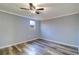Light filled bedroom shows vinyl flooring and a large window at 3048 Holiday Lake Dr, Holiday, FL 34691