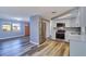 Open kitchen featuring stainless steel appliances, white cabinets, and modern gray flooring at 3048 Holiday Lake Dr, Holiday, FL 34691